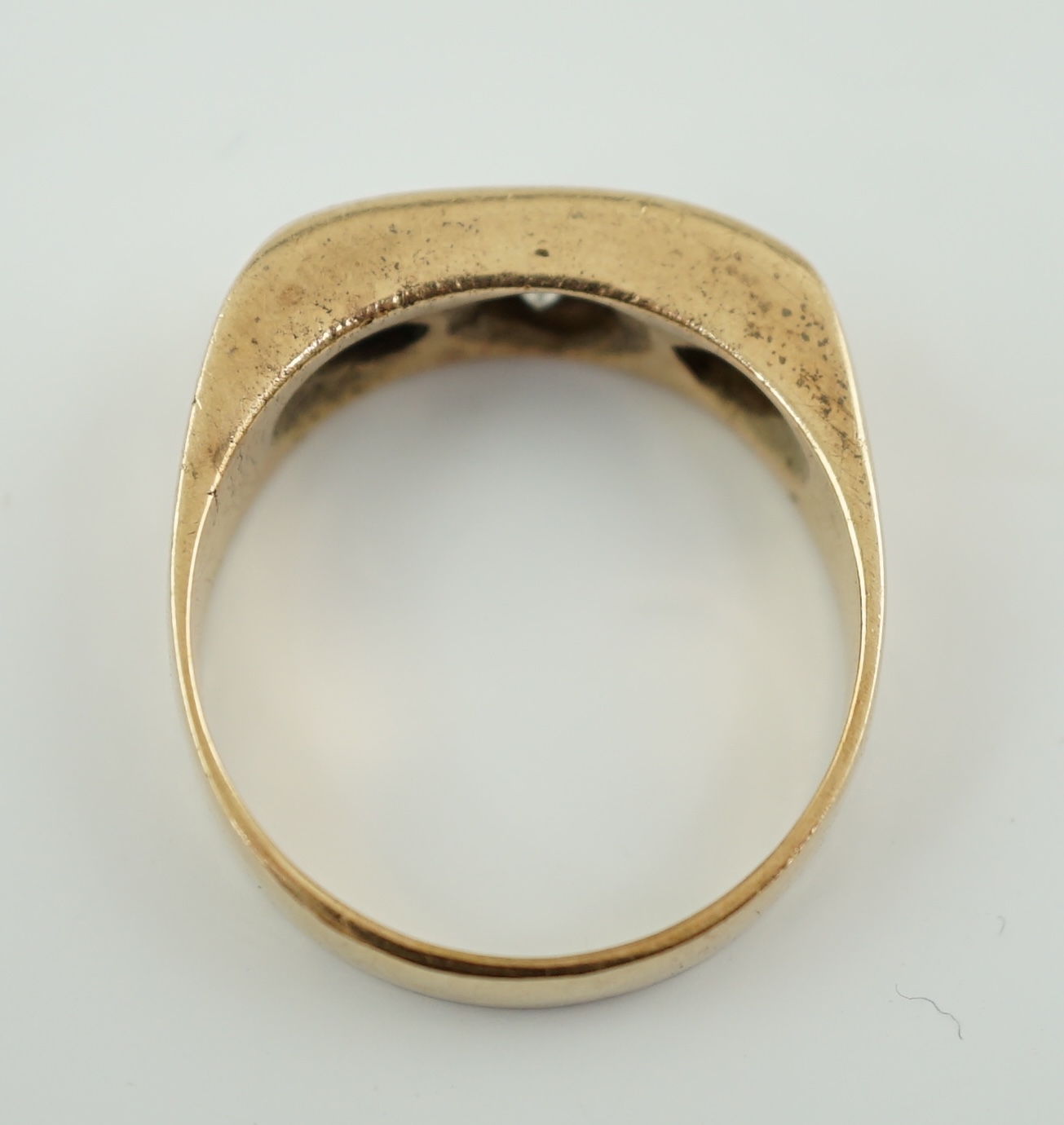 A gold and channel set three stone diamond ring